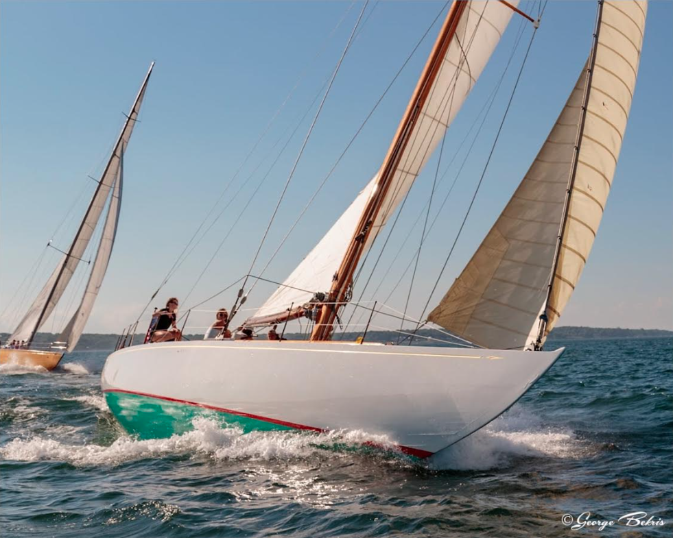 Historic GLEAM sailing yacht heeling in the wind while sailing on the ocean.